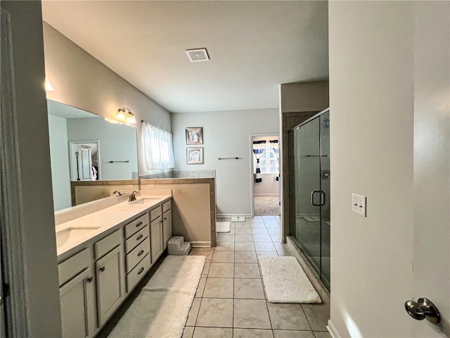 bathroom featuring tile patterned flooring, vanity, and an enclosed shower