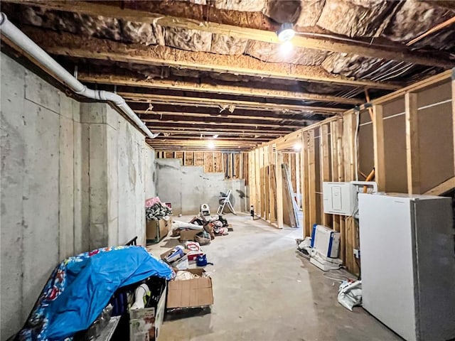 basement featuring white refrigerator