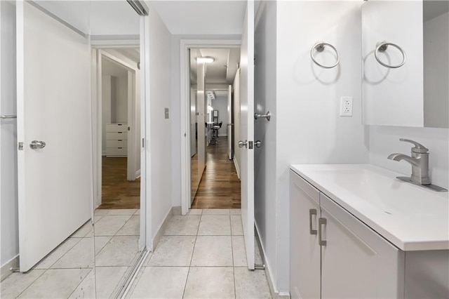 bathroom featuring tile patterned flooring, vanity, and baseboards