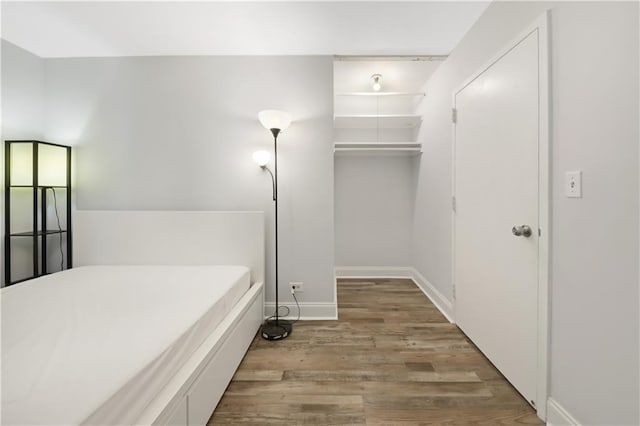 interior space featuring baseboards and wood finished floors