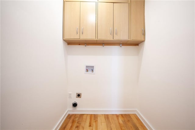 laundry room with light hardwood / wood-style flooring, electric dryer hookup, washer hookup, and cabinets