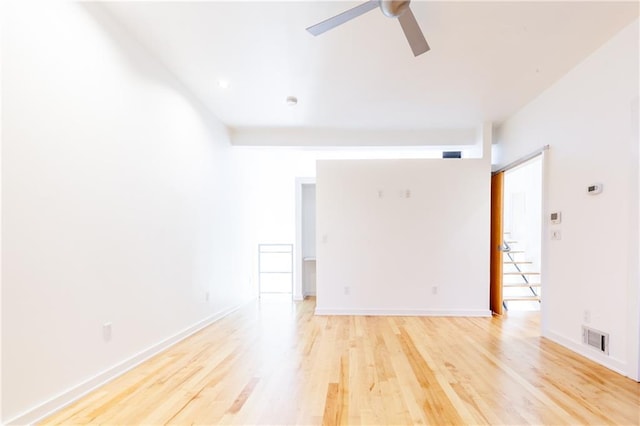 empty room featuring light hardwood / wood-style flooring and ceiling fan