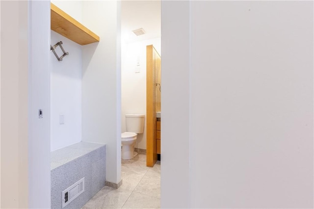 bathroom featuring toilet and tile patterned floors