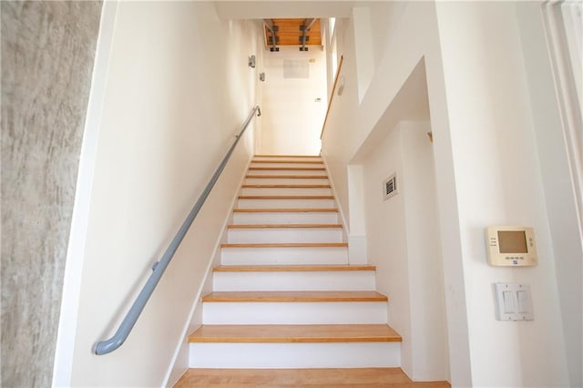 stairway with hardwood / wood-style floors