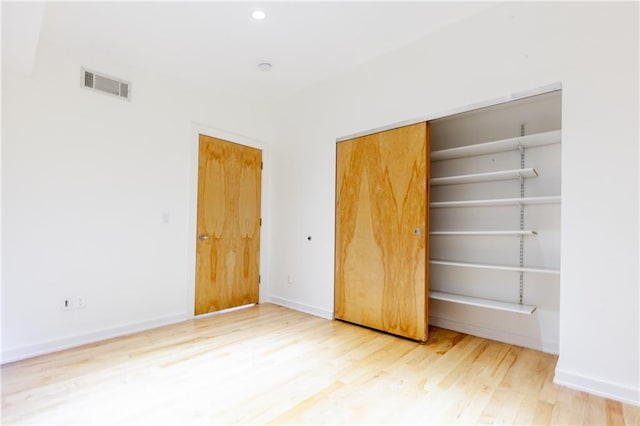 unfurnished bedroom featuring a closet and wood-type flooring