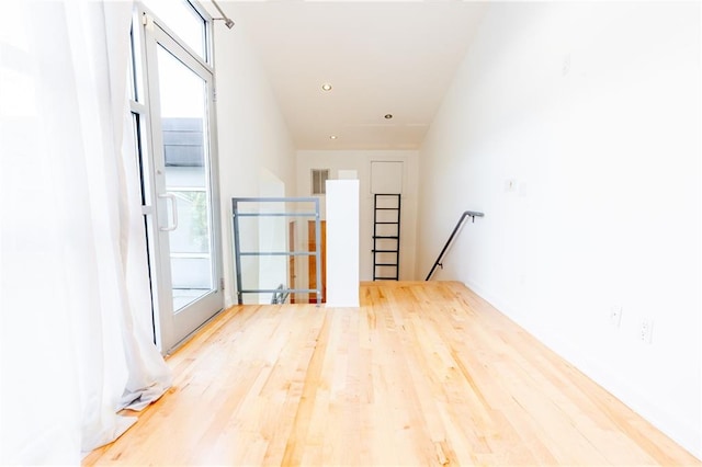 hallway with hardwood / wood-style floors