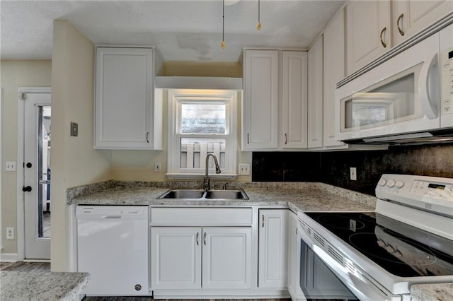 kitchen featuring white cabinets, white appliances, tasteful backsplash, and sink