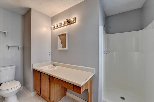 bathroom with tile patterned floors, walk in shower, a textured ceiling, vanity, and toilet