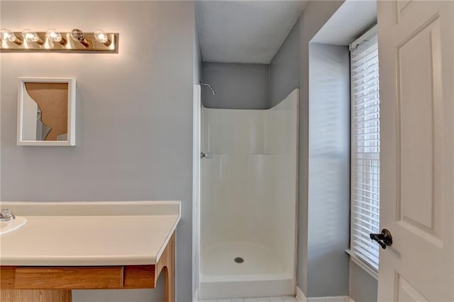 bathroom with tile patterned floors and walk in shower