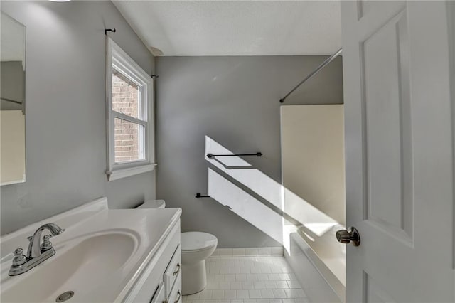 bathroom with tile patterned floors, vanity, and toilet