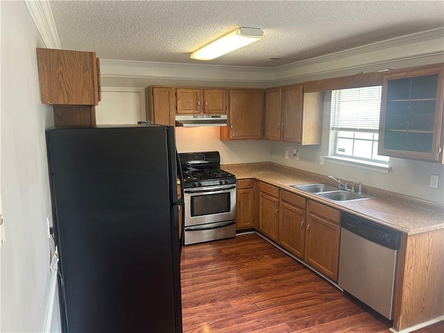 kitchen featuring a sink, a textured ceiling, appliances with stainless steel finishes, and under cabinet range hood
