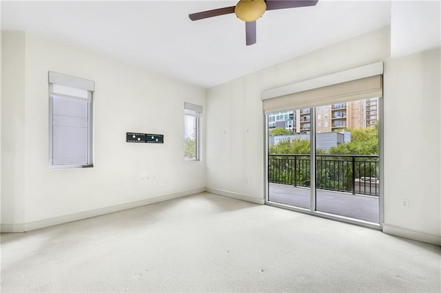 carpeted spare room with ceiling fan