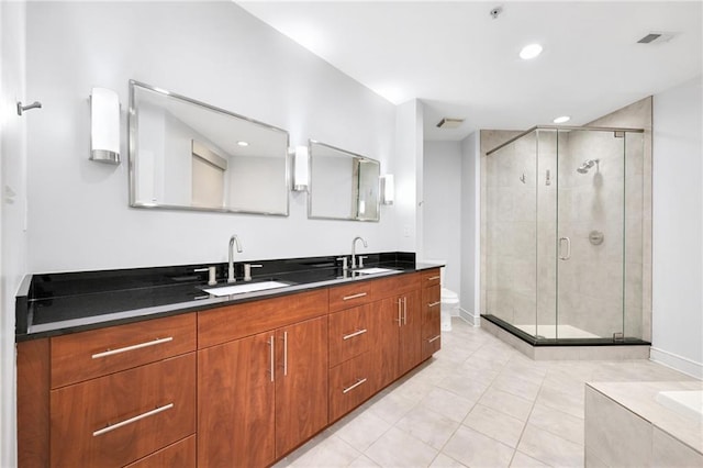 full bathroom featuring vanity, toilet, tile patterned floors, and separate shower and tub