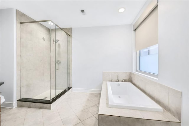 bathroom with independent shower and bath and tile patterned flooring