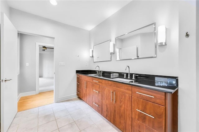 kitchen featuring sink, ceiling fan, and light hardwood / wood-style flooring