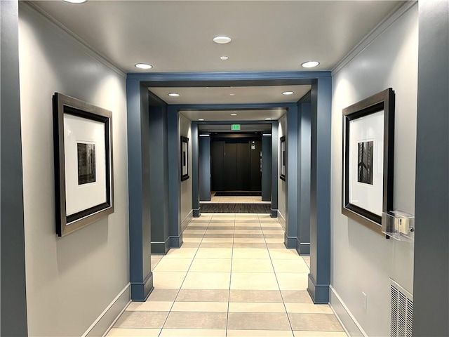 hall with crown molding, light tile patterned flooring, and elevator