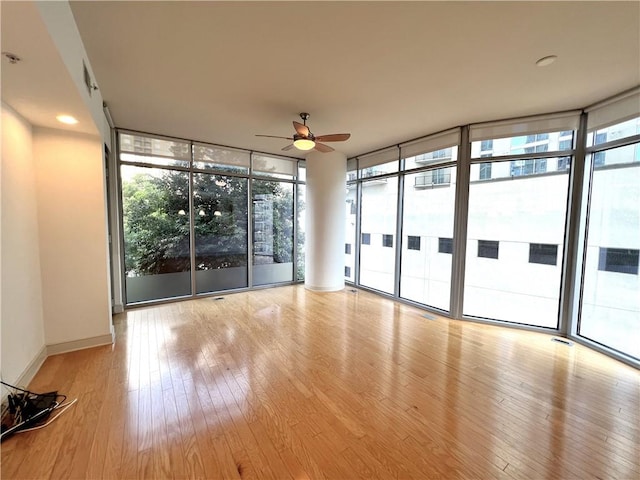 unfurnished sunroom with ceiling fan and a wealth of natural light