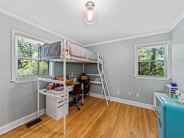 bedroom with baseboards, light wood-style flooring, visible vents, and multiple windows