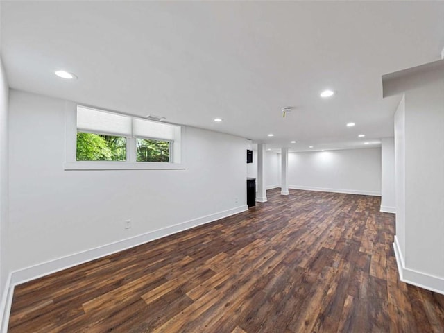 below grade area featuring baseboards, dark wood-style flooring, and recessed lighting