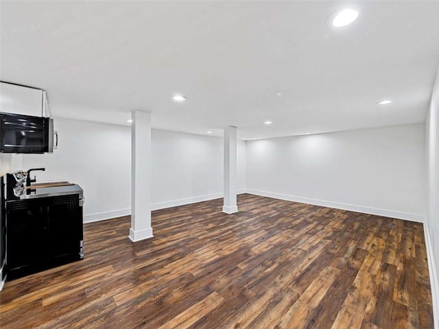 finished below grade area featuring baseboards, wood finished floors, and recessed lighting