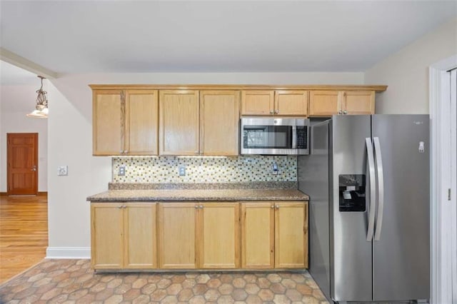 kitchen with appliances with stainless steel finishes, light brown cabinets, and decorative backsplash