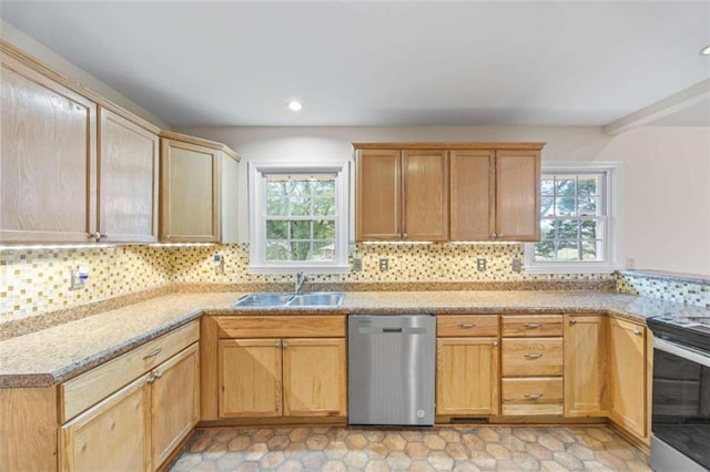 kitchen with appliances with stainless steel finishes, light brown cabinets, tasteful backsplash, and sink