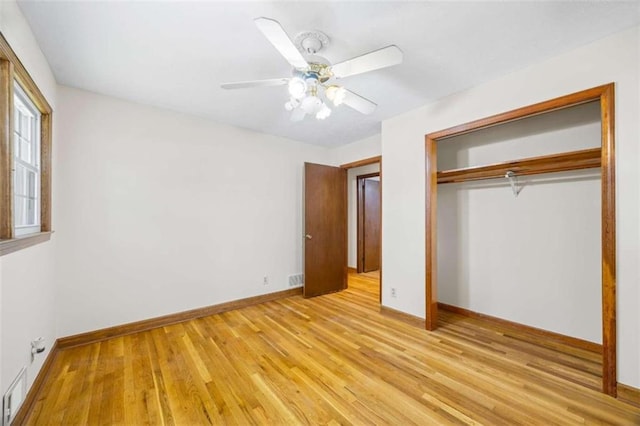 unfurnished bedroom featuring a closet, ceiling fan, and light hardwood / wood-style flooring