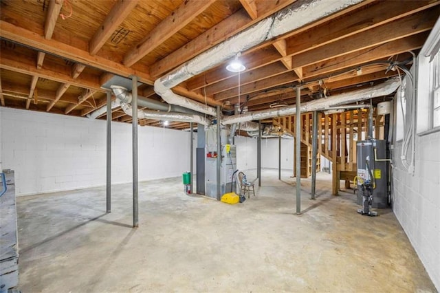 basement featuring water heater and heating unit