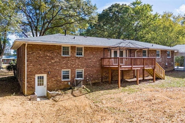 back of house featuring cooling unit and a deck