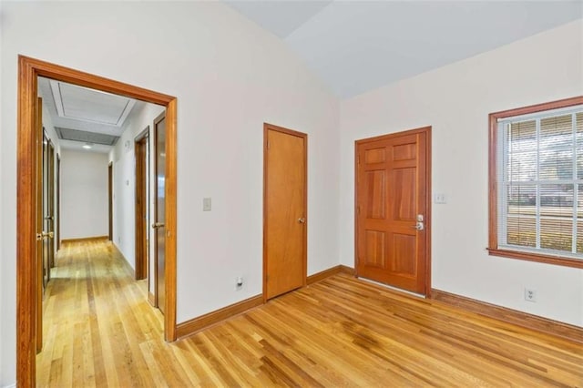 interior space featuring lofted ceiling and light hardwood / wood-style floors