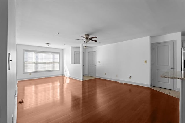 unfurnished living room with ceiling fan and light hardwood / wood-style floors