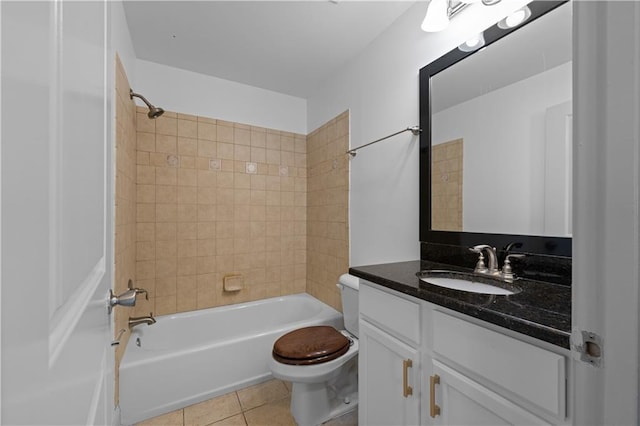 full bathroom with tile patterned flooring, vanity, tiled shower / bath combo, and toilet