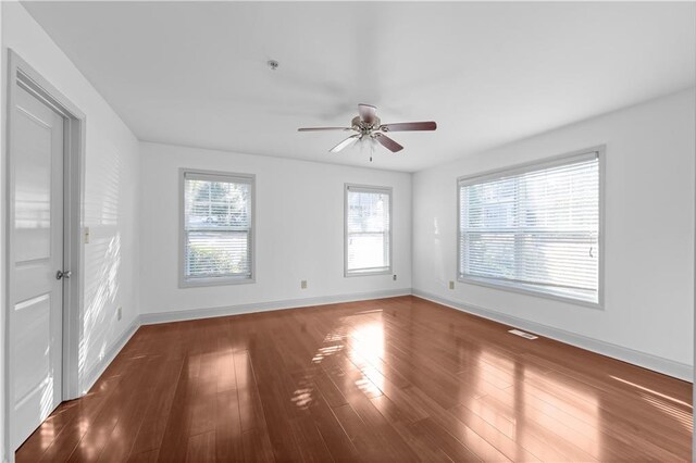 spare room featuring ceiling fan and dark hardwood / wood-style flooring