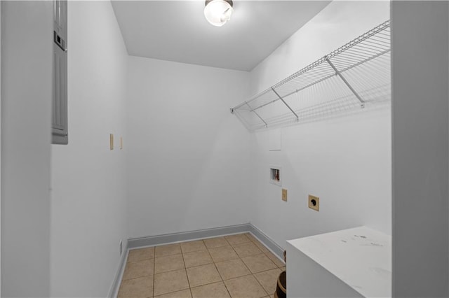 washroom featuring electric dryer hookup, hookup for a washing machine, and light tile patterned floors