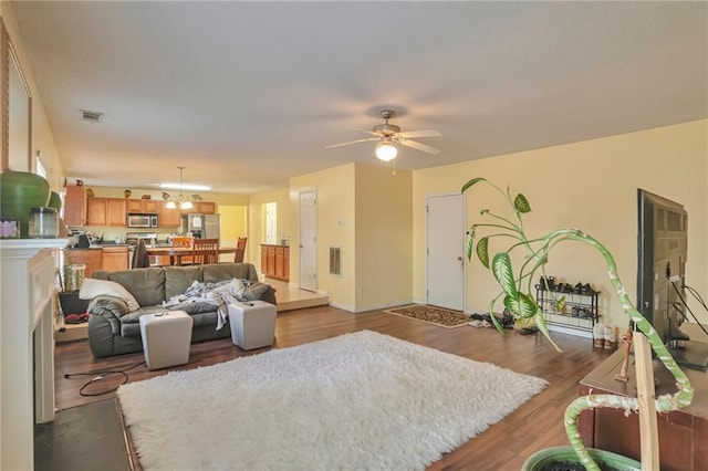 living room with hardwood / wood-style floors and ceiling fan