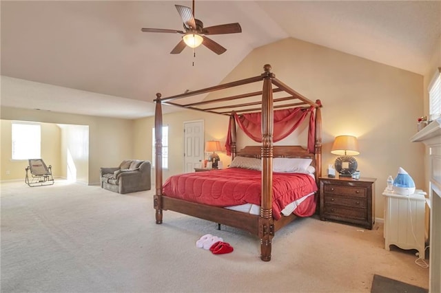bedroom featuring multiple windows, ceiling fan, carpet, and vaulted ceiling