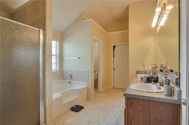 full bathroom featuring vanity, separate shower and tub, toilet, and vaulted ceiling