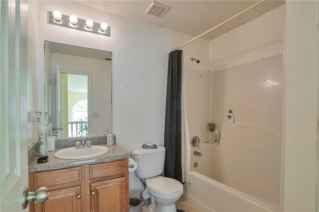 full bathroom featuring vanity, a textured ceiling, toilet, and shower / bath combo with shower curtain
