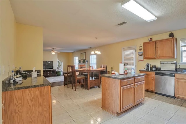 kitchen with dishwasher, light tile patterned floors, pendant lighting, a kitchen island, and ceiling fan with notable chandelier