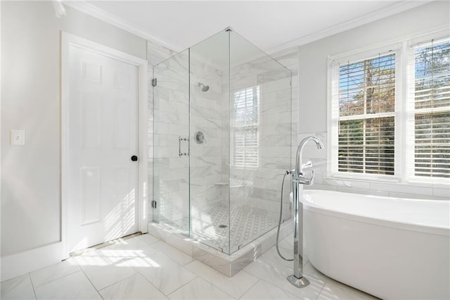 full bathroom with a shower stall, a freestanding bath, and crown molding