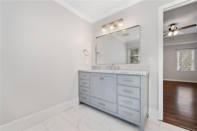 bathroom featuring a ceiling fan, baseboards, crown molding, and vanity