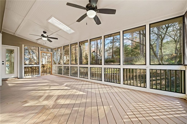 unfurnished sunroom featuring ceiling fan and lofted ceiling with skylight