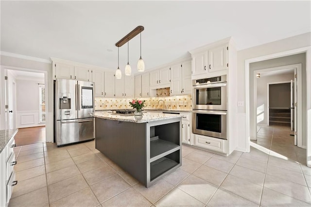 kitchen with light stone counters, stainless steel appliances, backsplash, open shelves, and crown molding