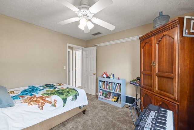 bedroom with carpet floors, ceiling fan, visible vents, and a textured ceiling