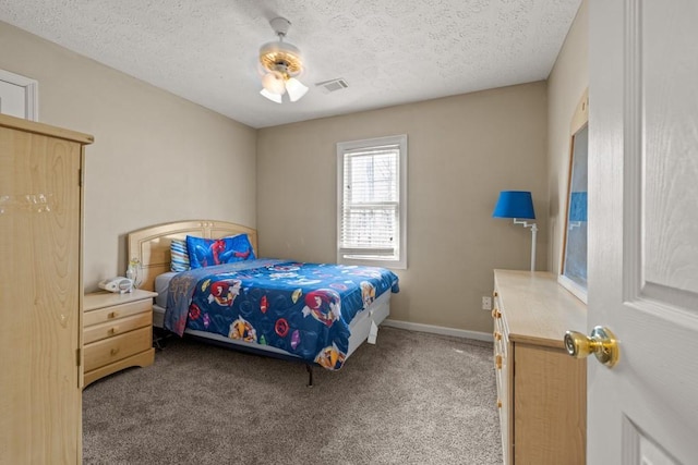 carpeted bedroom with a textured ceiling, ceiling fan, visible vents, and baseboards