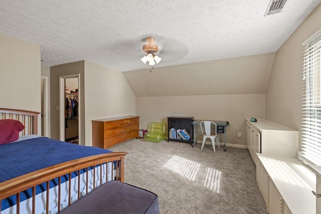 carpeted bedroom featuring lofted ceiling, visible vents, a textured ceiling, and multiple windows