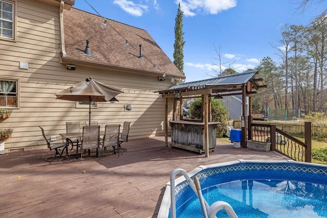 view of swimming pool featuring a trampoline, a fenced in pool, outdoor dining area, a gazebo, and a wooden deck