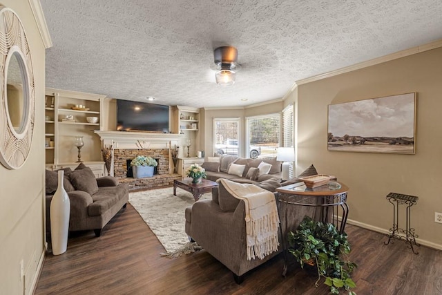 living room with baseboards, a fireplace with raised hearth, ornamental molding, wood finished floors, and a textured ceiling