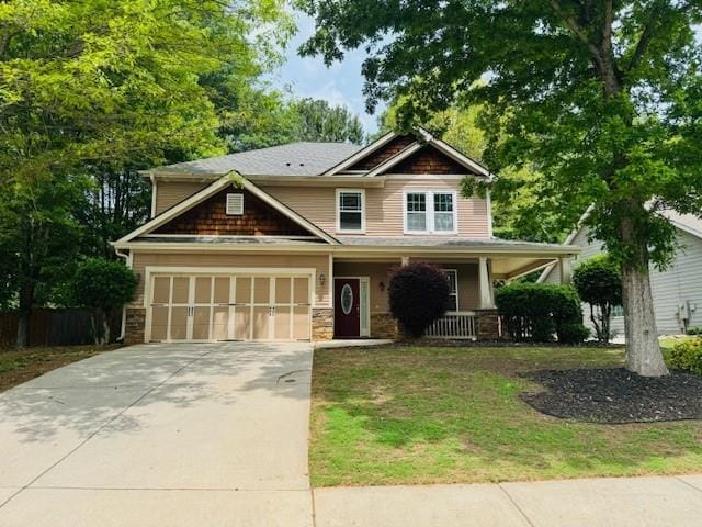 1714 Boulder Walk Ln SE, Atlanta, GA 30316 - craftsman-style home featuring covered porch, concrete driveway, an attached garage, and stone siding