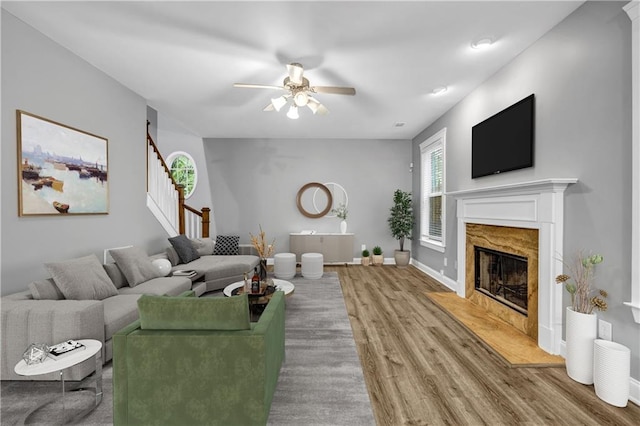 1714 Boulder Walk Ln SE, Atlanta, GA 30316 - living room featuring wood finished floors, a ceiling fan, a premium fireplace, stairs, and baseboards